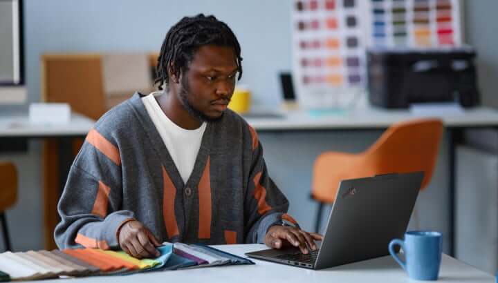 Man selecting fabrics using laptop